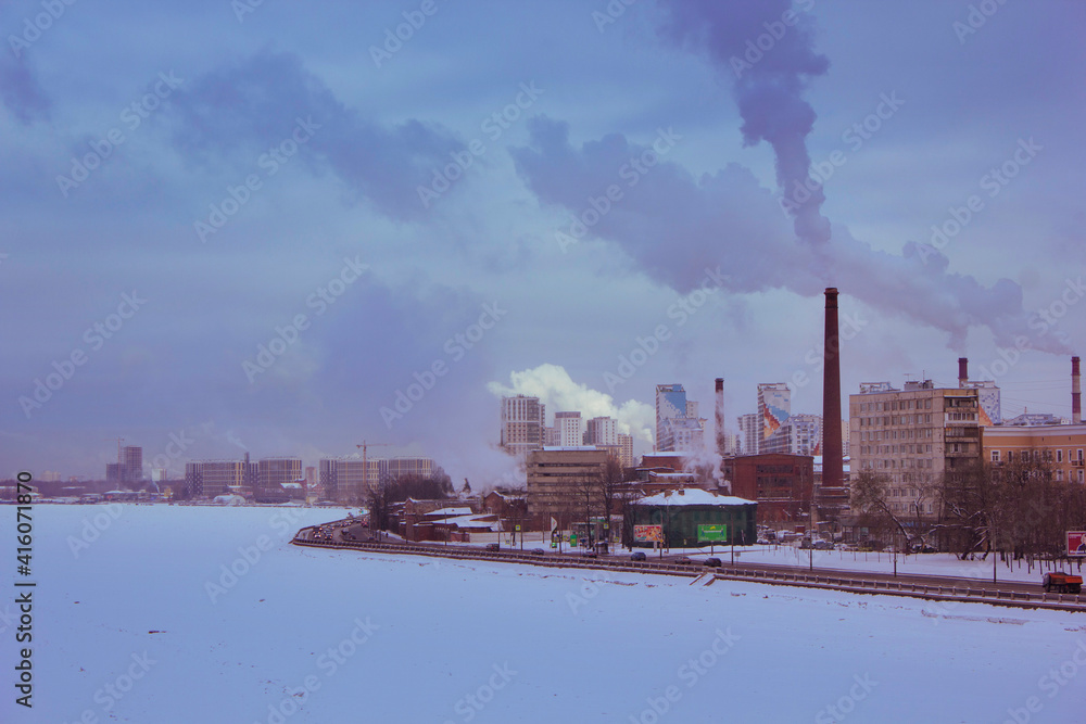 cityscape, smoke comes from the chimneys of the factory, polluting the atmosphere