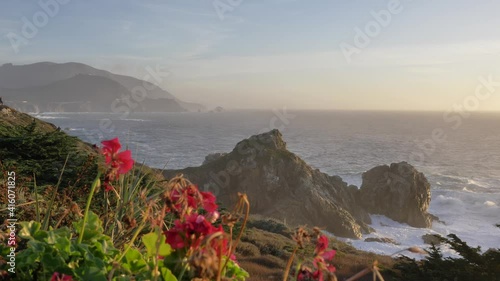 Pfeiffer Bridge Sunset at scenic Big Sur coast of pacific ocean with beautiful flowers and green plants