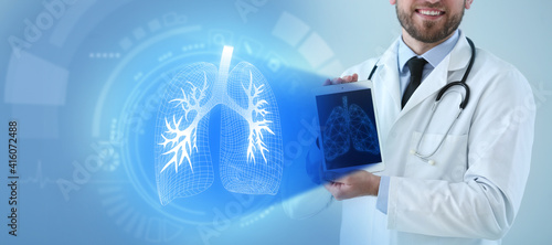 Male doctor holding tablet ...