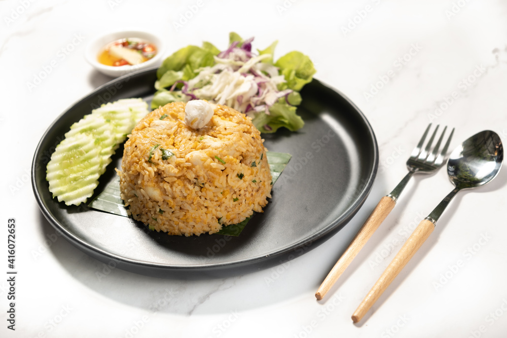 Crab Meat Fried Rice with folk and spoon on marble background ready to eat Crab Meat Fried Rice with folk and spoon on marble background ready to eat
