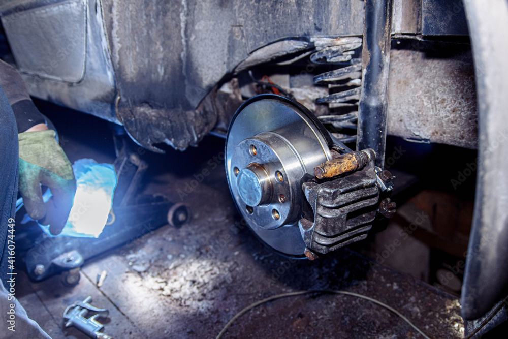 Fototapeta premium New car brake disc, brake system repair concept in garage