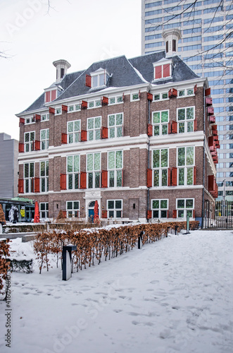Rotterdam, The Netherlands, February 14, 2021: 17th century historic Schielandshuis building with its snow-covered garden on a winter day