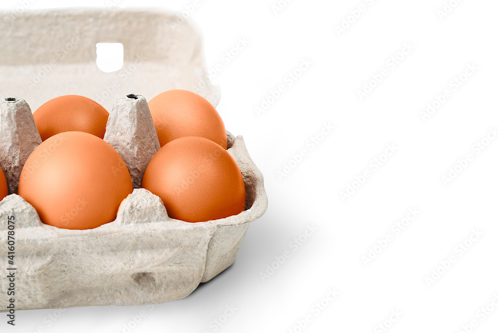 Brown eggs in a cardboard box. Isolated on a white background with a shadow. Brown eggs in a cardboard box. Isolated on a white background with a shadow.