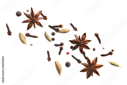 various flying spices for making masala tea isolated on white background