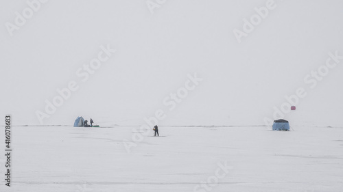 People are ice fishing on frozen Lake Superior