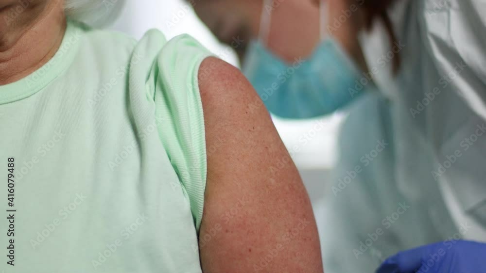 close up doctor holding syringe and using cotton before make injection to old patient. Health and medical concept. Selective focus close up doctor holding syringe and using cotton before make injection to old patient. Health and medical concept. Selective focus