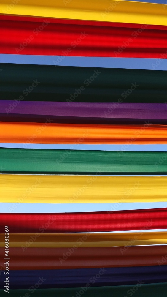 bright colorful stripes of fabric in the sky background bright colorful stripes of fabric in the sky background