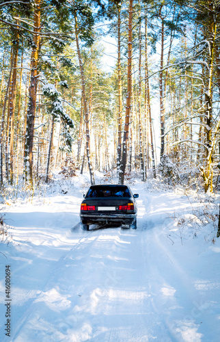 car on a winter forest road