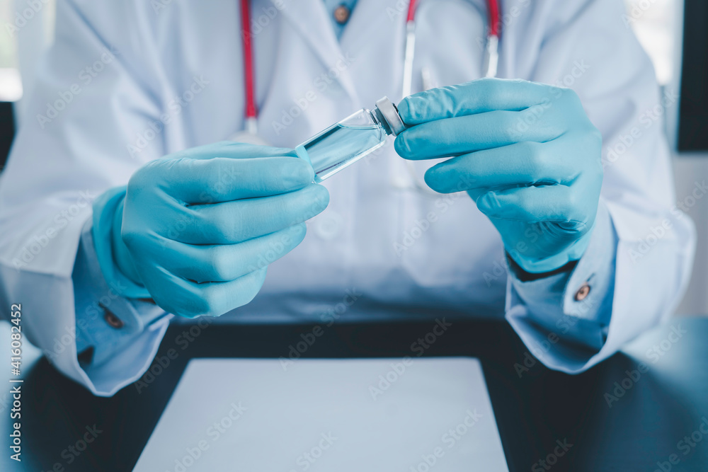 Doctors in blue gloves with new vaccine for coronavirus Certified by the World Health Organization Tested in children and the elderly, vaccine and treatment concepts Doctors in blue gloves with new vaccine for coronavirus Certified by the World Health Organization Tested in children and the elderly, vaccine and treatment concepts