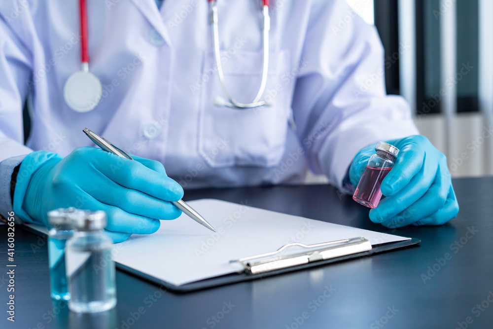 Doctors in blue gloves with new vaccine for coronavirus Certified by the World Health Organization Tested in children and the elderly, vaccine and treatment concepts Doctors in blue gloves with new vaccine for coronavirus Certified by the World Health Organization Tested in children and the elderly, vaccine and treatment concepts