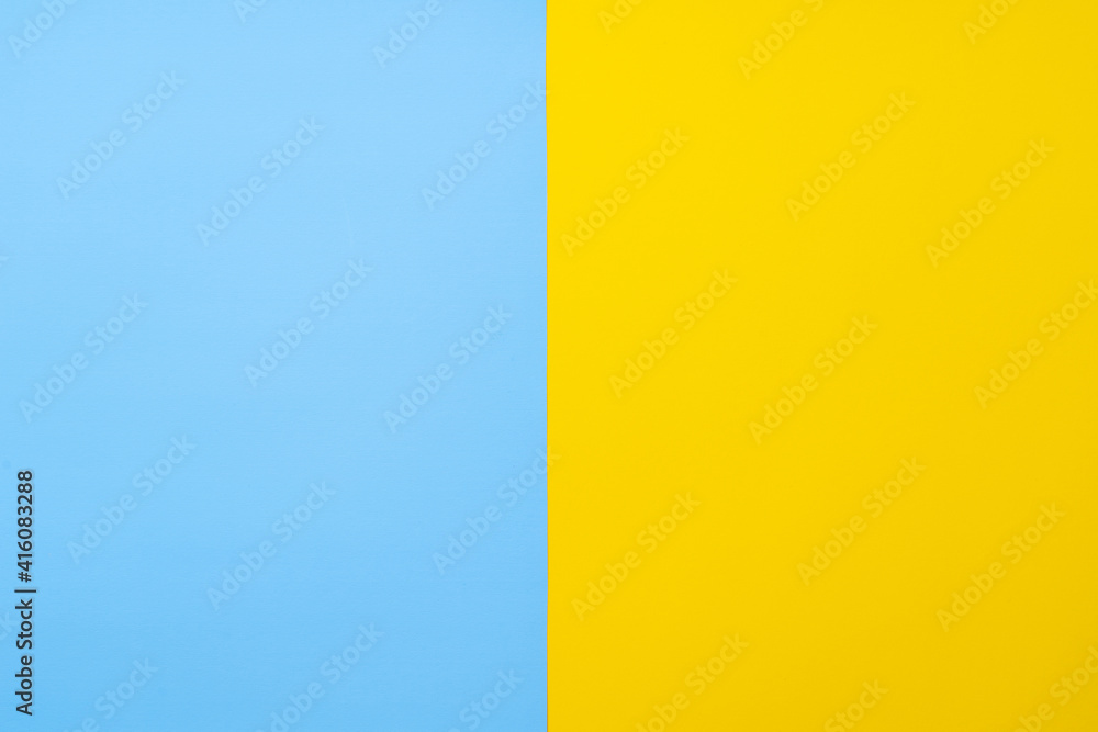 Fototapeta premium Yellow-blue background bisected vertically. Blue and yellow sheet of paper