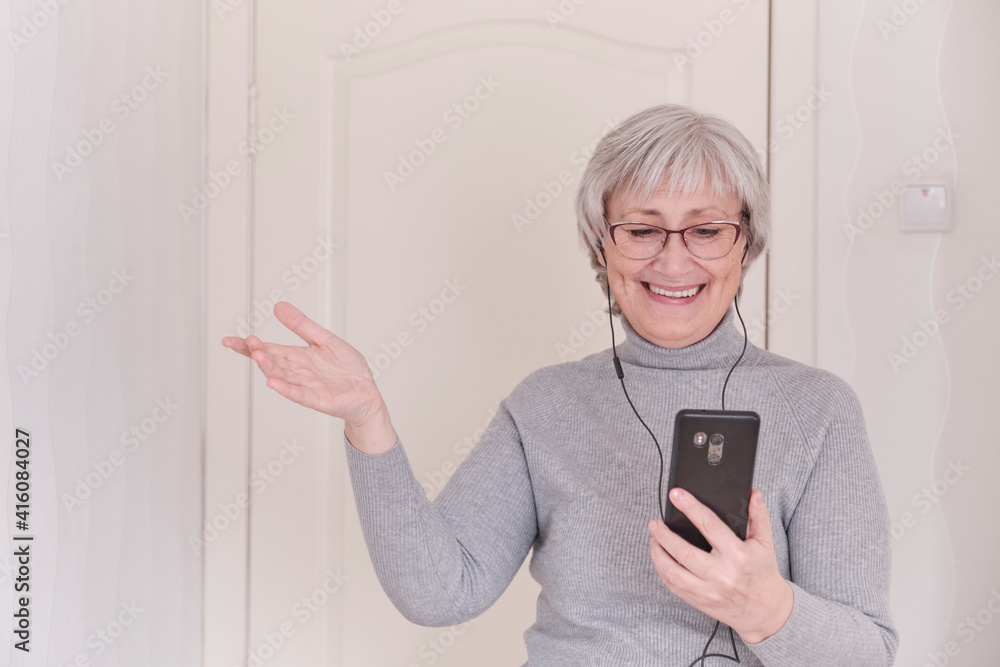 Senior woman talking on mobile phone at home. Senior woman talking on mobile phone at home.
