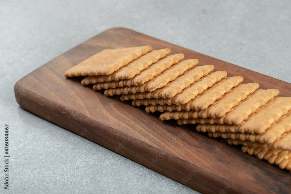 A wooden cutting board with delicious crackers A wooden cutting board with delicious crackers