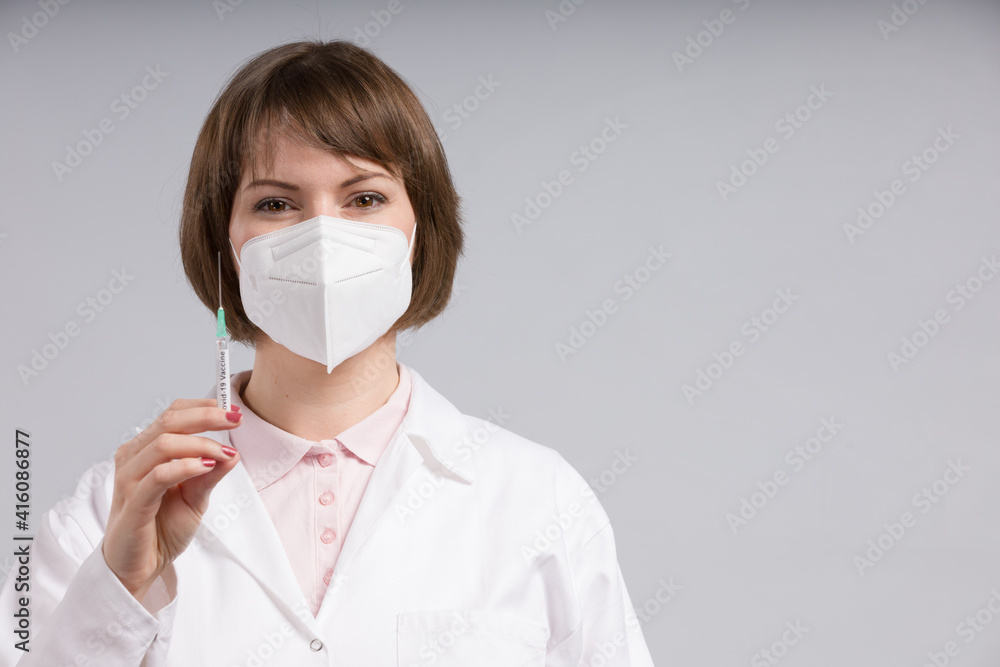 female doctor or nurse with syringe pulled up with a vaccination serum female doctor or nurse with syringe pulled up with a vaccination serum