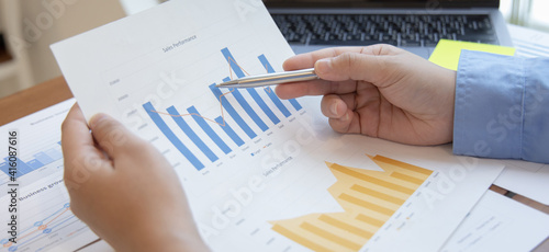 Financial businessmen analyze the graph of the company's performance to create profits and growth, Market research reports and income statistics, Financial and Accounting concept.