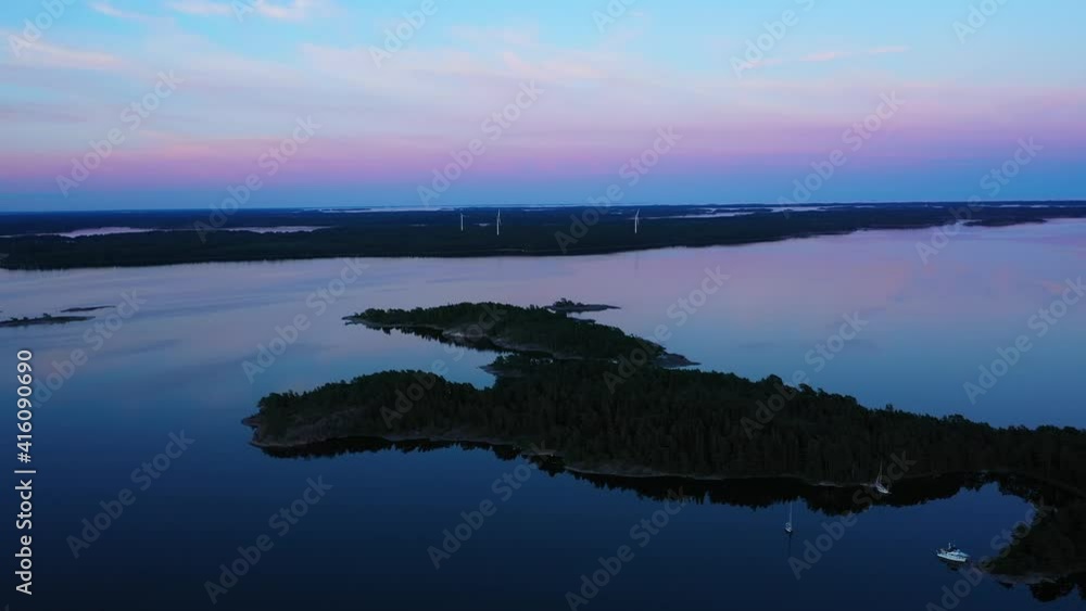 Aerial drone view of islands and windmills, morning dawn, in the Archipelago of Scandinavia Aerial drone view of islands and windmills, morning dawn, in the Archipelago of Scandinavia