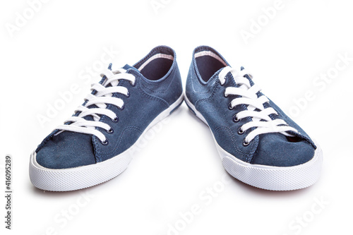 blue sneakers on white background with copy space. Youth shoes.