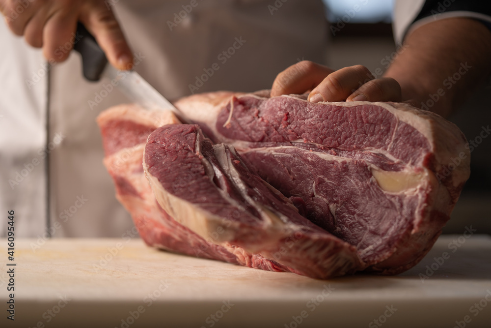 butcher processes the meat in the butchery