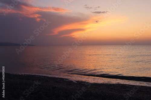 Seascape sunset on the seashore, lilac pink sky and sea