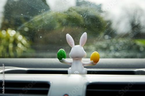 Easter bunny with easter eggs solar powered toy in car window interior