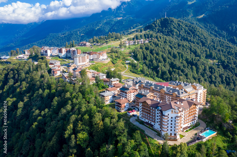 Summer aerial view of the Ski Resort Rosa Khutor. A complex of hotels on the site of the former Olympic village of Rosa Plateau at an altitude of 1170 m from sea level. Krasnaya Polyana, Sochi, Russia