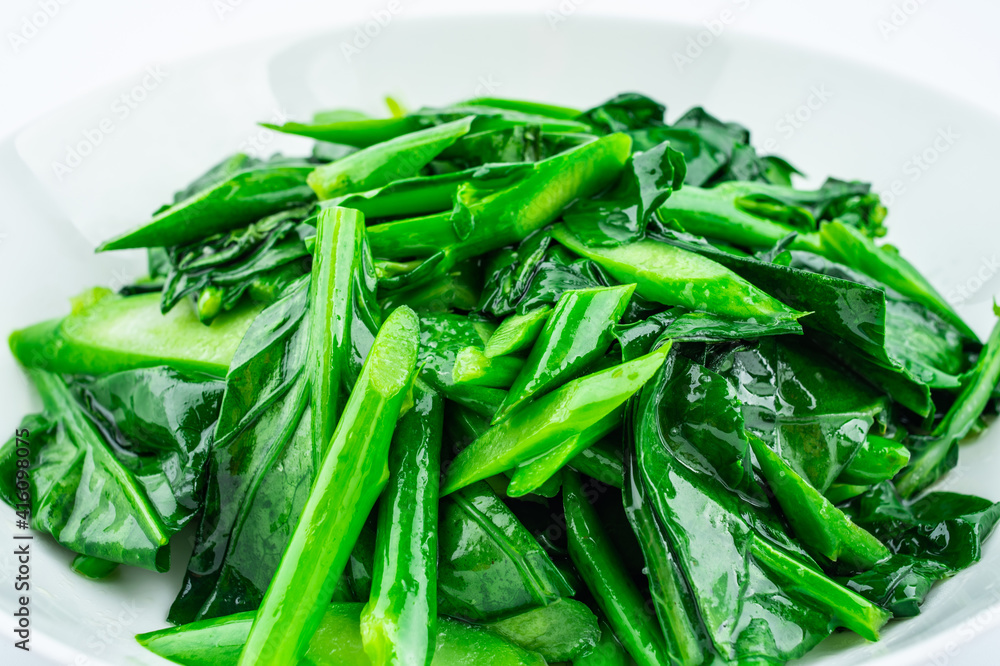 A dish of fried kale on white background