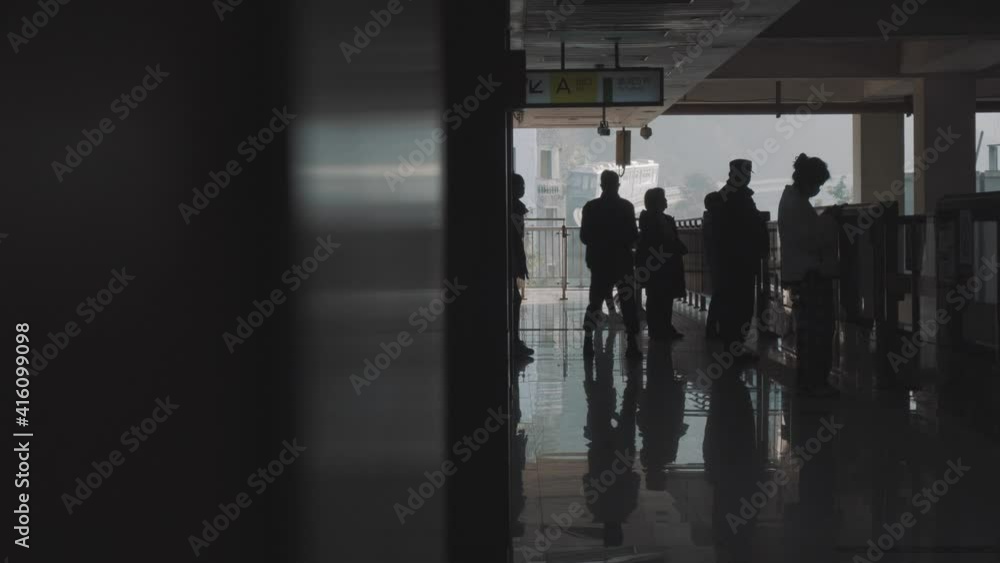 A group of tourists are taking pictures at the station A group of tourists are taking pictures at the station