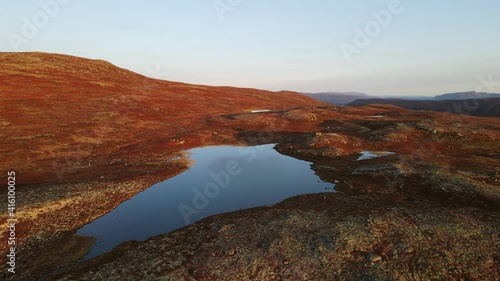 Beautiful landscape of mountain plateau with mountain formations and lakes in Southern Norway. Areal footage, sunset time in Autumn photo