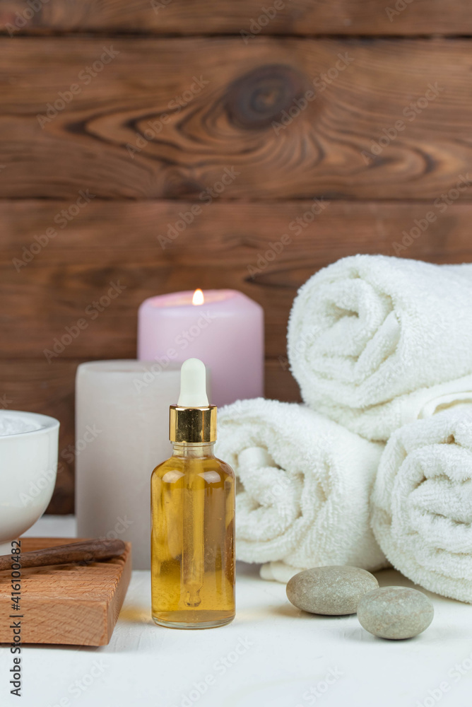 Herbal therapy, traditional medicine and homeopathy concept. Towel with salt, herbs, candles and bottle natural organic oil essence serum. Set for spa, massage and aromatherapy Herbal therapy, traditional medicine and homeopathy concept. Towel with salt, herbs, candles and bottle natural organic oil essence serum. Set for spa, massage and aromatherapy