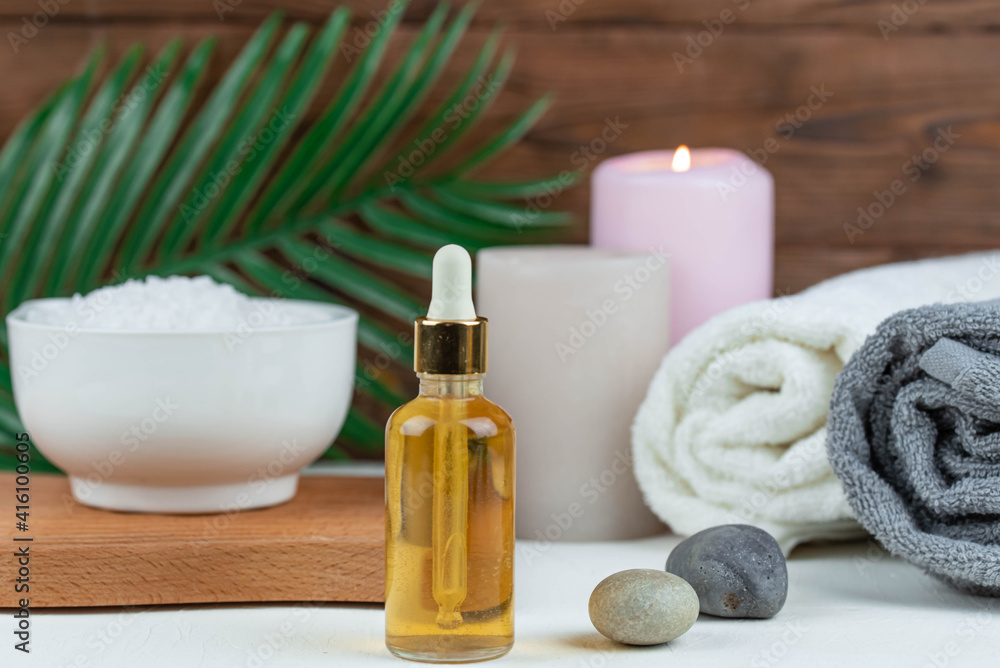 Herbal therapy, traditional medicine and homeopathy concept. Towel with salt, herbs, candles and bottle natural organic oil essence serum. Set for spa, massage and aromatherapy Herbal therapy, traditional medicine and homeopathy concept. Towel with salt, herbs, candles and bottle natural organic oil essence serum. Set for spa, massage and aromatherapy