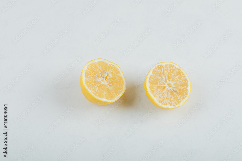 Two slices of lemon on a white background Two slices of lemon on a white background