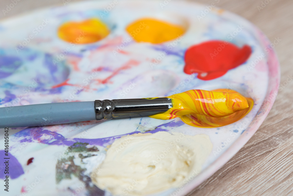Obraz premium Artist's palette, top view. Mixing paints, brush. Texture, background