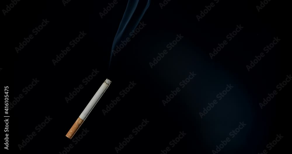 Cigarette with smoke on dark background Cigarette with smoke on dark background