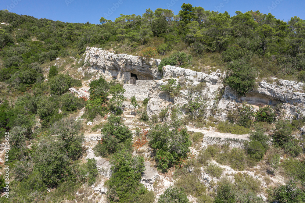 Aerial drone view of hideout of Tito's Cave on Josip Broz on Vis Island in Croatia summer