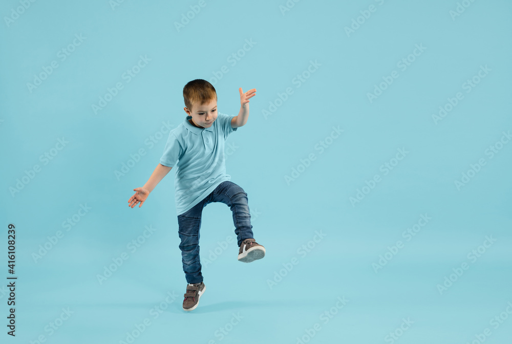 Happy, cheering. Childhood and dream about big and famous future. Pretty little boy isolated on blue studio background. Dreams, imagination, education, facial expression, emotions concept. Happy, cheering. Childhood and dream about big and famous future. Pretty little boy isolated on blue studio background. Dreams, imagination, education, facial expression, emotions concept.