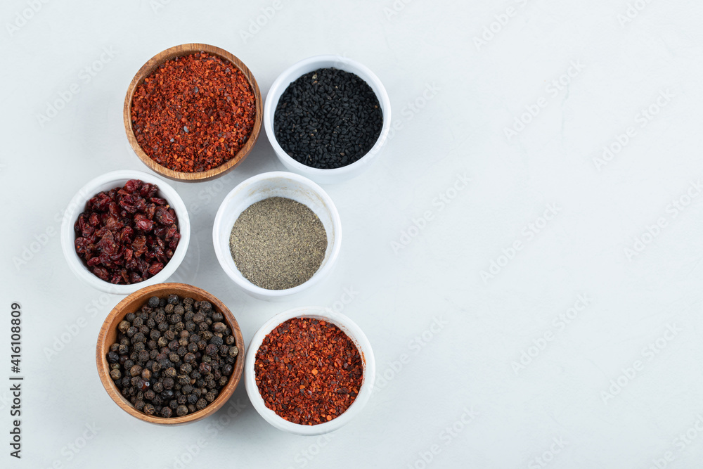 Many bowls of spices on a white background Many bowls of spices on a white background