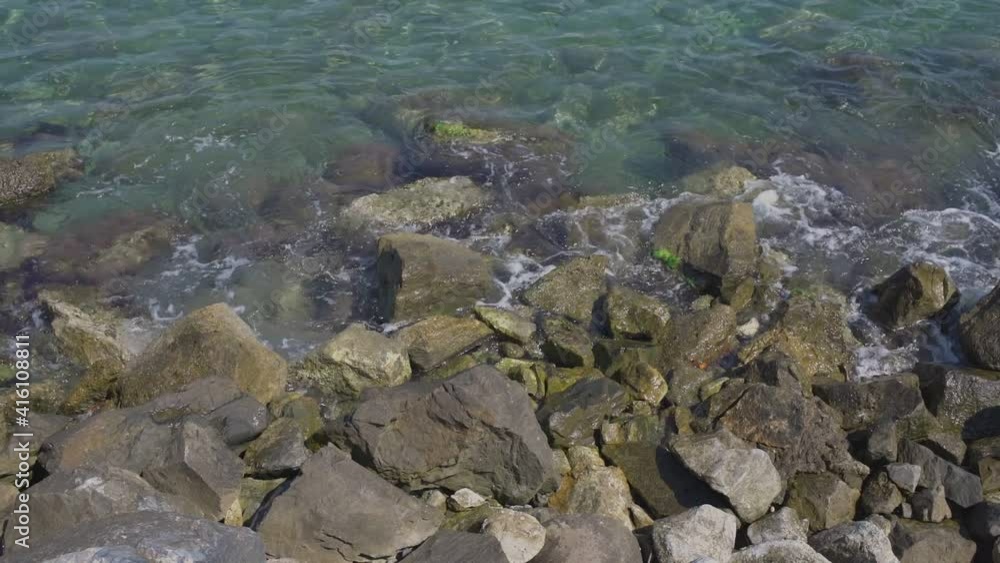 Sea waves break down on shore of bay rocks during sea surf. Top view. Sea waves break down on shore of bay rocks during sea surf. Top view.