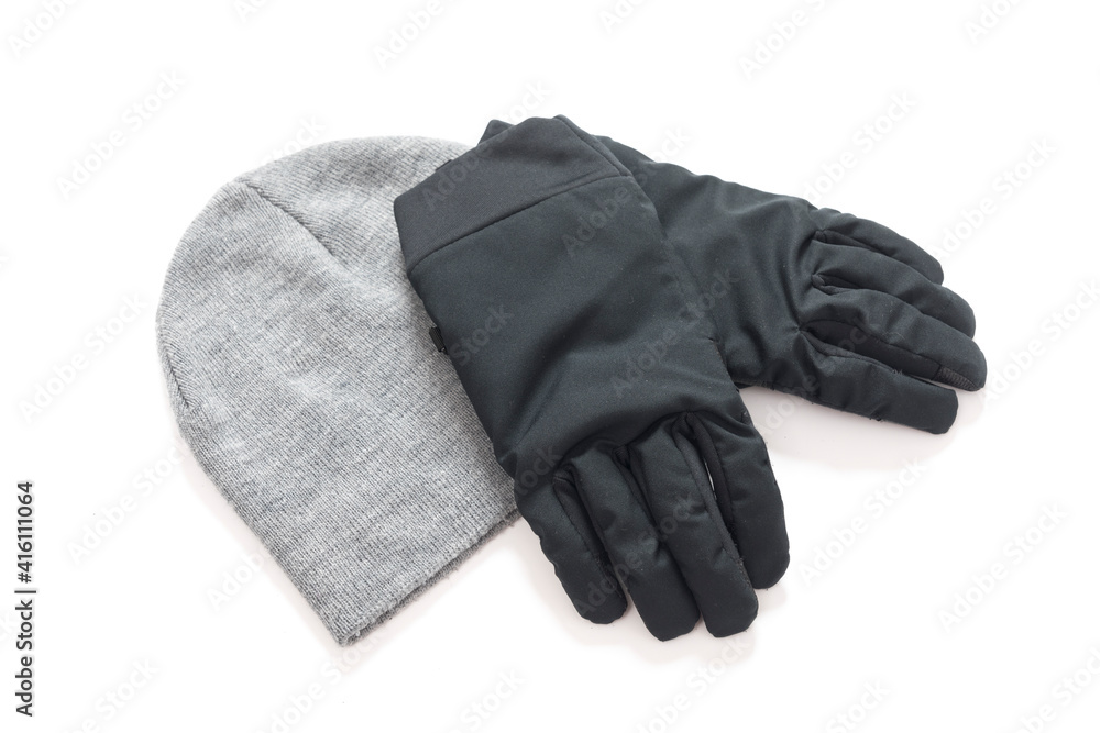 Grey knitted mens hat and gloves isolated on a white background. Grey knitted mens hat and gloves isolated on a white background.
