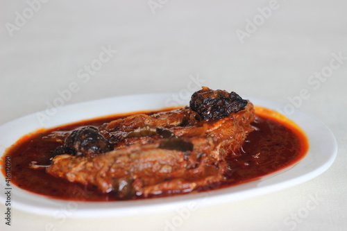 Sardines curry is a traditional central Kerala fish curry. photo