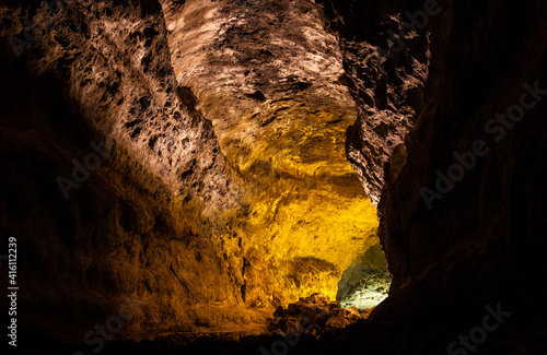 Los Verdes cave illuminated in Lanzarote island, Spain. Dark underground passage heading into light