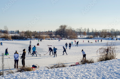 people skating on a frozen pond in winter