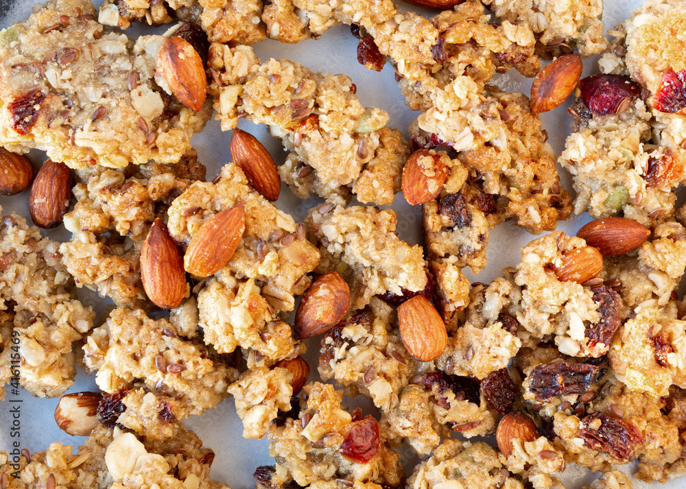Close view of whole grains granola with fruit and nuts on a plate illuminated with natural light. Close view of whole grains granola with fruit and nuts on a plate illuminated with natural light.