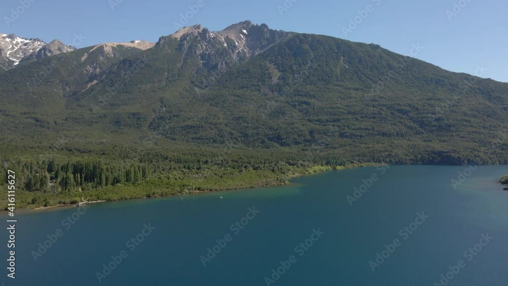 Aerial pan right of Epuyen lake with mountains covered in pine tree woods, Patagonia Argentina Aerial pan right of Epuyen lake with mountains covered in pine tree woods, Patagonia Argentina