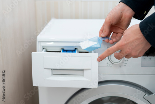 person load the washing powder detergent in the machine