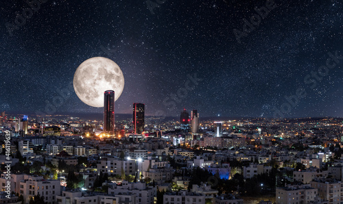 Photos Full moon above modern buildings in the new downtown of Amman city