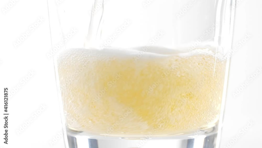pouring beer into glass on white background slow motion frothy bubbles pouring beer into glass on white background slow motion frothy bubbles