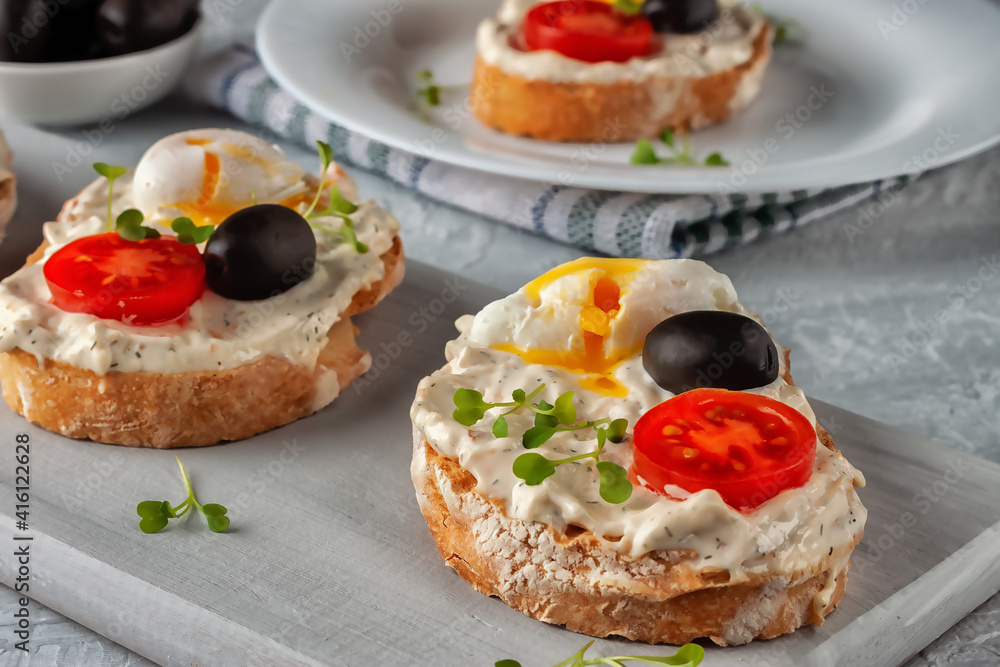 Bruschetta with tomato, olives and poached quail egg Bruschetta with tomato, olives and poached quail egg
