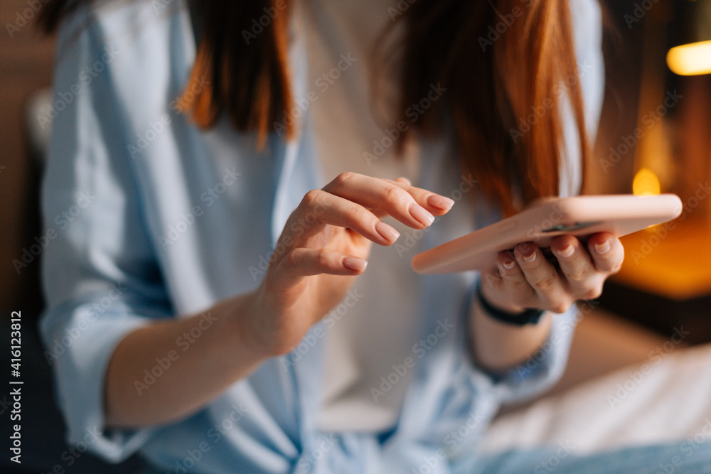 Close-up view of unrecognizable woman texting message on mobile cellphone for communication and chatting on social online. Closeup of female hands hold mobile phone modern gadget typing sms to friend.
