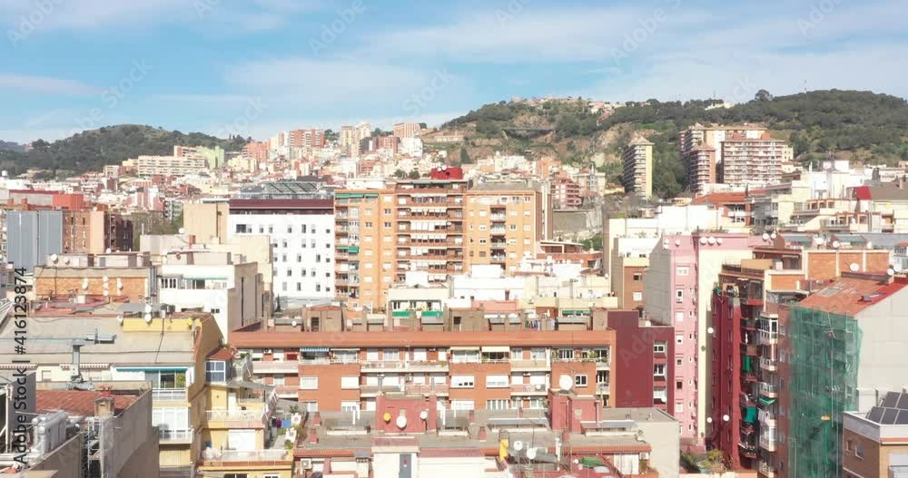 Aerial Drone Pedestal up Tilt of houses in barcelona with carmel bunker mountain in the background Aerial Drone Pedestal up Tilt of houses in barcelona with carmel bunker mountain in the background