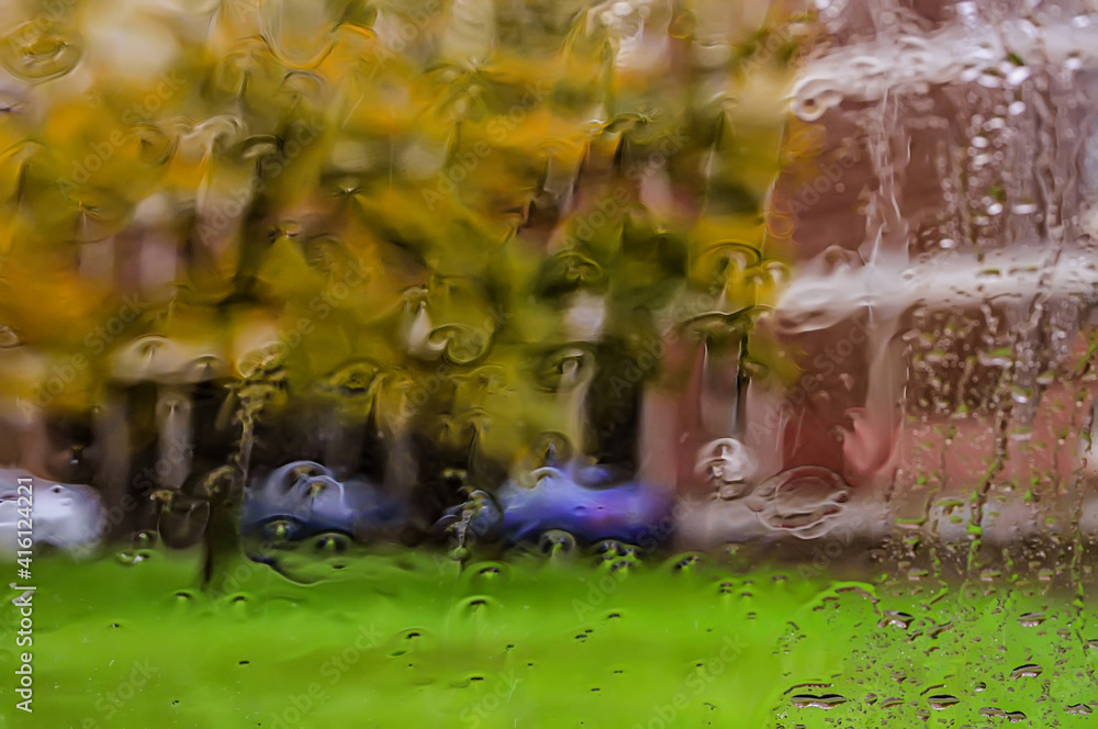 View of street through glass with rain drops. View of street through glass with rain drops.